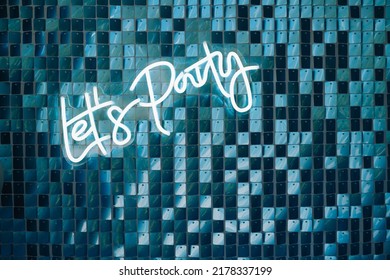 Photo zone decor with balloons of silver and blue collars , neons text birthday party let's party