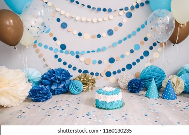 Photo Zone With Paper Garlands, Balloons, Paper Honeycombs, Paper Balls, Pom Poms, Confetti And Cream Cake. Birthday Cake. Smash Cake. One Year. Blue, Brown, Gold, Beige, Turquoise Colors.