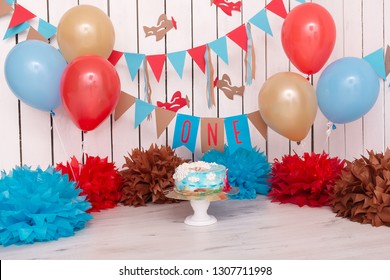 Photo Zone With Paper Garlands, Balloons, Paper Balls, Pom Poms, Confetti And Cream Cake. Birthday Cake. Smash Cake. One Year. Blue, Gold, Beige, Brown Colors. Pilot, Sky