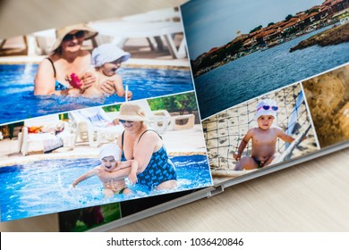 Photobook Album On Deck Table With Travel Photos