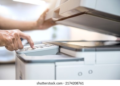 Photocopier printer, Close up hand office man press copy button on panel to using the copier or photocopy machine for scanning document or printing paper or Xerox a sheet. - Shutterstock ID 2174208761