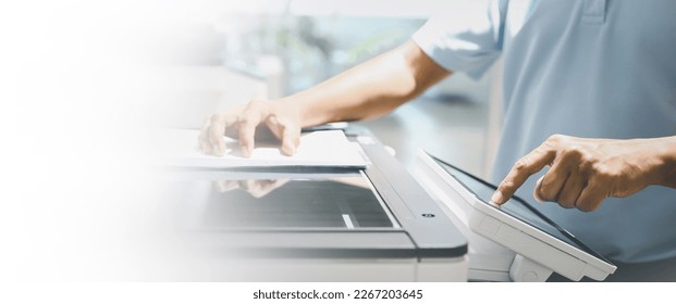 Photocopier printer, Close up hand office man press copy button on panel to using the copier or photocopy machine for scanning document or printing paper or Xerox a sheet. - Shutterstock ID 2267203645