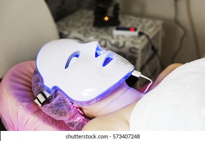 Photodynamic therapy facial mask on woman's face