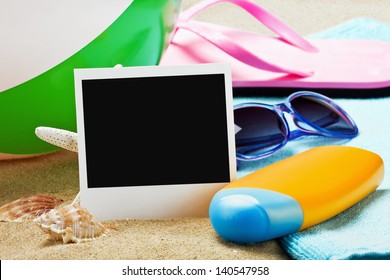 Photoframe And Beach Gear On The Sea Sand