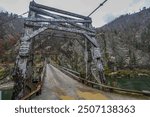 photogragh of historic wood and cable bridge that has been replaced on the Salmon River South of Riggins, ID.