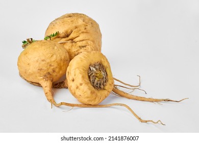 Photograph of 3 maca roots on a white background