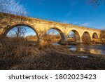 Photograph of a beautiful and historic five arch bridge in southern Wisconsin in the golden light of an early winter day.