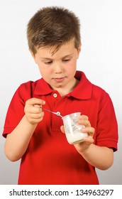 photograph of a child eating yogurt over white background