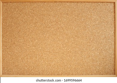 Photograph of a cork panel in a wooden frame ideal for backgrounds and textures. Panel for notes and photos of all kinds. - Shutterstock ID 1699596664