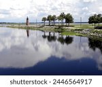 A photograph created at Lake Tohopekaliga in Kissimmee, Florida. It was taken from the Lakefront park and may include the lighthouse and trees near it. 