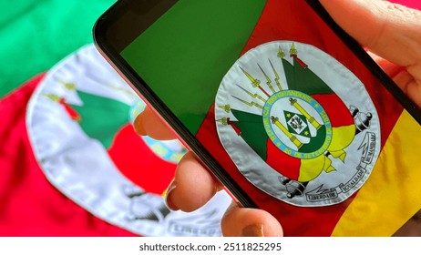 Photograph the Flag of the State of Rio Grande do Sul in Brazil with your smartphone. Gaucho flag. - Powered by Shutterstock