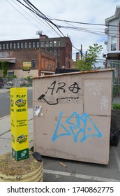 A Photograph Of A Graffiti On A Clothing Donation Bin. 