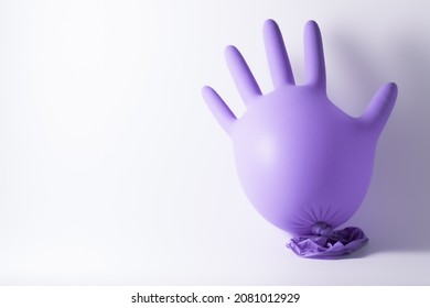 Photograph Of An Inflated Purple Nitrile Glove On A White Background.