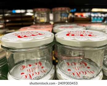 A photograph of jars for jam and spices arranged on a shelf creates a cozy and functional image of kitchen storage - Powered by Shutterstock