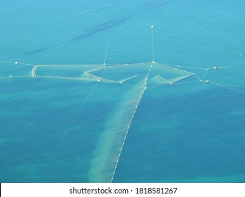   Photograph Of A Large Fishing Net In The Blue Sea