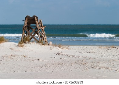 Photograph Of A Lifeguard Chair At A Quiet Surfside Beach With Ocean Waves Rolling In The Background  No People