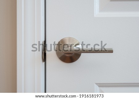 Photograph of a modern styled nickel closet door lever