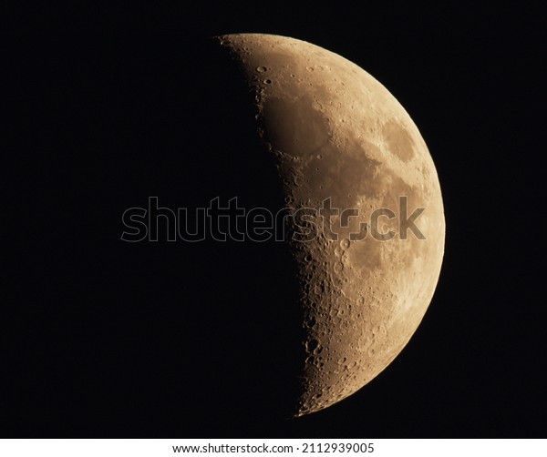Photograph of\
Moon in the first quarter lunar\
phase.
