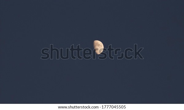 Photograph of moon shot\
with telescope lens.