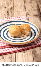 A Photograph Of A Muffin Cake Topped With Fresh Homemade Cheese Crumbs On A Blue Circle Plate. One Of The Muffins Was Cut On A Wooden Canvas And A Red And White Checkered Cloth.