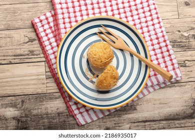 A Photograph Of A Muffin Cake Topped With Fresh Homemade Cheese Crumbs On A Blue Circle Plate And A Wooden Fork. One Of The Muffins Was Cut On A Wooden Canvas And A Red And White Checkered Cloth.