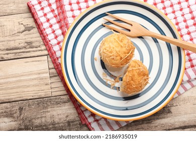 A Photograph Of A Muffin Cake Topped With Fresh Homemade Cheese Crumbs On A Blue Circle Plate And A Wooden Fork. One Of The Muffins Was Cut On A Wooden Canvas And A Red And White Checkered Cloth.