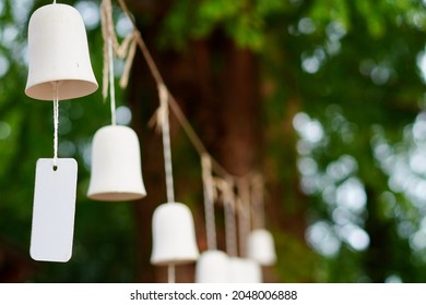 Photograph Of An Object With A Wind Chime Hanging