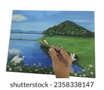 A photograph of a person drawing a picture showing painting on plywood with acrylic paints. a picture of a reservoir Bang Phra Reservoir Chonburi Province, Thailand, beautiful white egrets flying arou