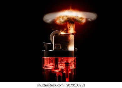 Photograph of a red backlit cigarette lighter on a black background. Concept photo. Lighter showing a nuclear explosion instead of a simple flame.