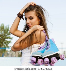 Photograph Of A Roller Derby Sexy Woman Holding Her Skates By The Laces, Outdoors