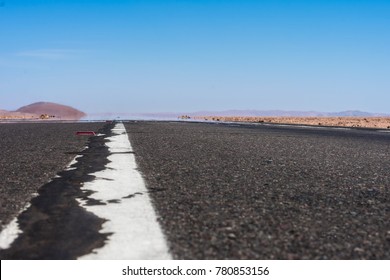 Photograph Of A Route, Road Or Asphalt Road With A Continuous Line Taken At The End Of The Floor, The Image Shows A Mirage And A Desert Landscape With A Lot Of Heat