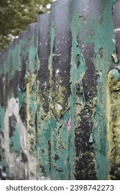 A photograph of a rusty, graffitied 