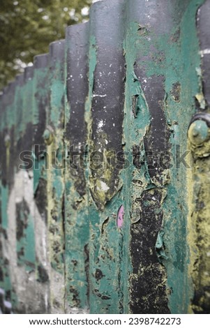 A photograph of a rusty, graffitied 