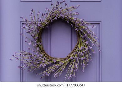 Photograph Of A Seasonal Summer Wreath On A Lavender Colored Door