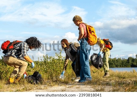 The photograph showcases a diligent group of volunteers engaged in a cleanup activity, demonstrating their commitment to environmental health. Each individual is equipped with gloves and bags