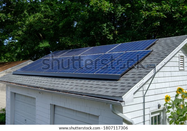 Photograph of solar panals installed on the roof\
of a detached two car\
garage.