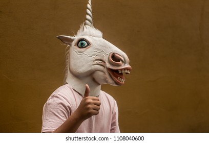 Photograph Of A Teen With A Funny Unicorn Mask