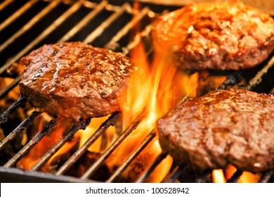 Photograph Of Three Tasty Beef Burgers On The Grill