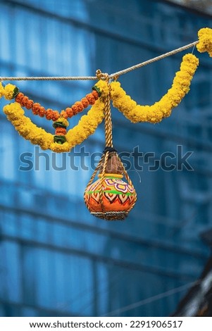 photograph of traditional dahi handi or Matka (earthen pot) tied up high on the Gokulashtami festival which is Lord Shri Krishna's birthday. Indian youth form a human pyramid to break the Dahi Handi