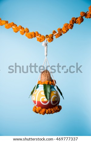 photograph of traditional dahi handi or Matka (earthen pot) tied up high on gokulashtami festival which is Lord Shri Krishna's birth day