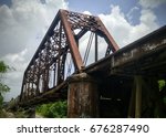 Photograph of Train on Railroad Bridge Over the Leaf River in Hattiesburg Mississippi on a Cloudy Day