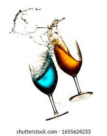 Photograph With Two Glasses And Different Liquids, Colliding With Each Other And Spreading The Liquid