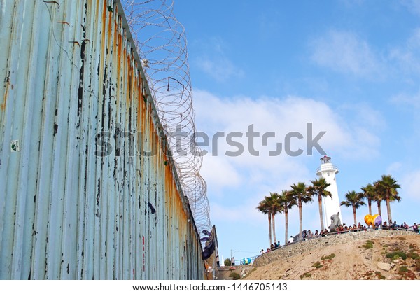 A photograph of the US - Mexico border on the\
Tijuana side. This is an editorial photograph taken in Tijuana\
Mexico on July 2nd, 2019.