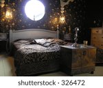 Photograph of a very classy and extraordinary master bedroom designed according feng shui guidelines with a circular window