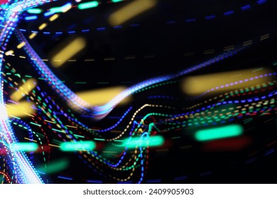 A photograph of vibrant multi-color dotted lights in a long exposure photo against a black background. Light painting photography - Powered by Shutterstock