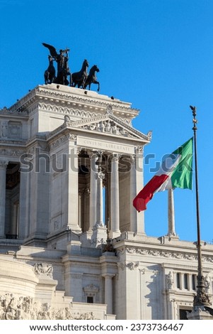 Photograph of the Victor Emmanuel II National Monument, capturing its imposing white marble edifice and statues. This iconic Roman landmark stands as a testament to Italy unification and first king.