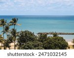 Photograph of the view of Candeias beach, Jaboatão dos Guararapes - state of Pernambuco, Brazil. Sky, sea, great barrier reef, trees, blue, water.