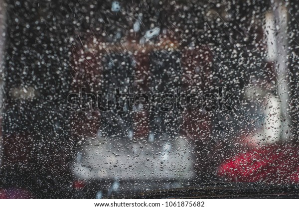 Photograph of a wet car\
window in car wash