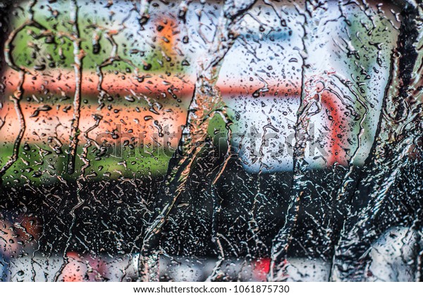 Photograph of a wet car\
window in car wash