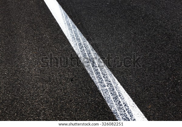   photographed close-up of road markings painted\
on the asphalt